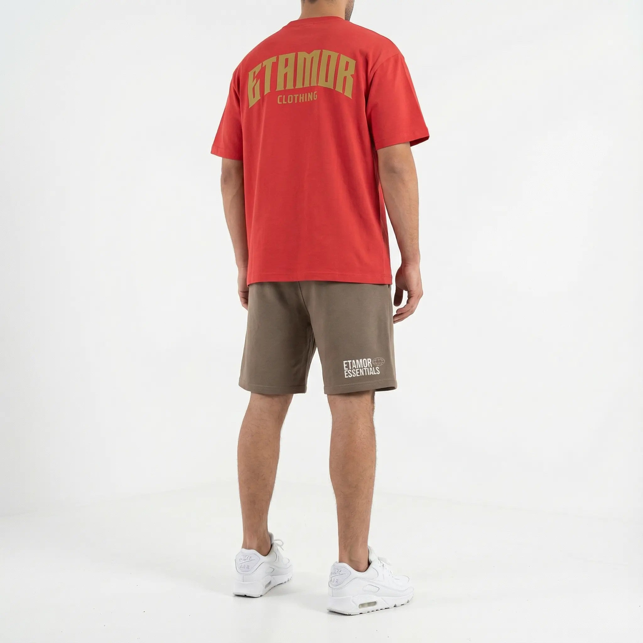 Person wearing a red t-shirt and brown shorts with 'ETAMOR CLOTHING' branding on a white background