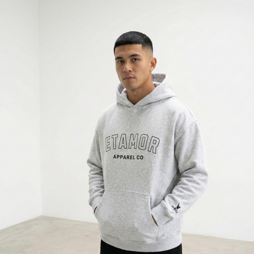 Person wearing a gray hoodie with 'ETAMOR APPAREL CO' text on a white background