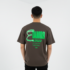 Person wearing a brown t-shirt with green text on the back against a white background