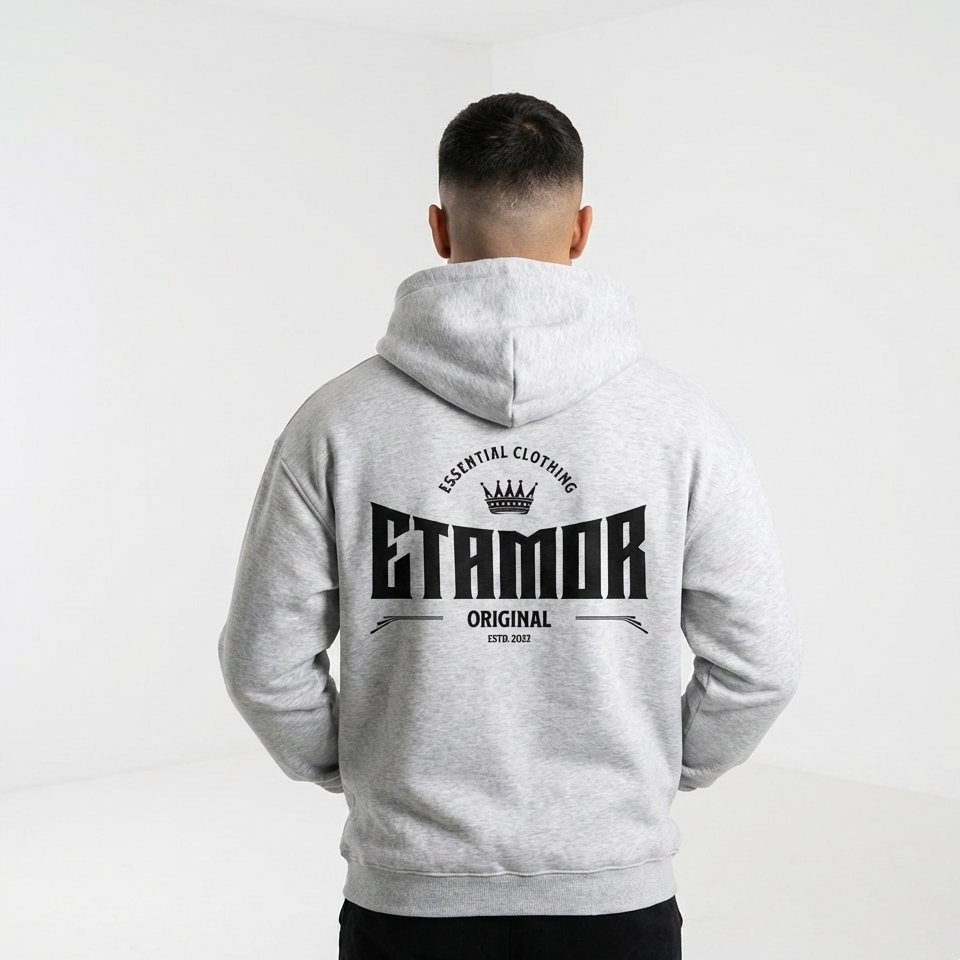Person wearing a gray hoodie with 'ETAMOR' branding on the back against a white background