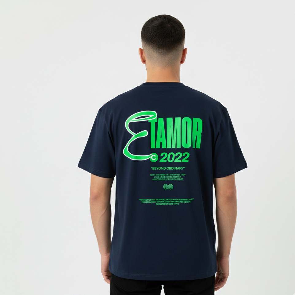 Person wearing a navy blue t-shirt with green text on the back, standing against a white background