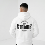 Person wearing a white hoodie with 'ETAMOR' branding on the back against a light gray background