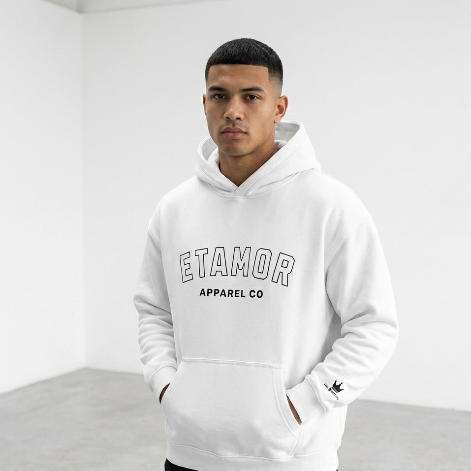 Person wearing a white hoodie with 'Etamor Apparel Co' text, standing against a plain background